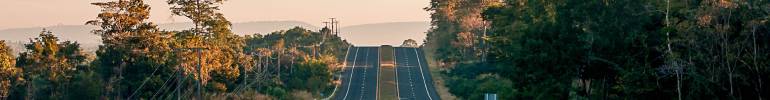 Right of way road rolling over the hill at sunset