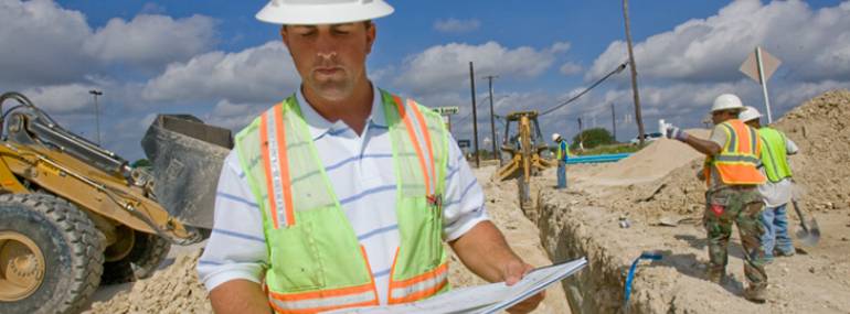 Construction man reading plans