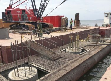 workers on buoyed platform for SH 334 Bridge construction