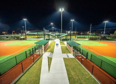 sidewalk between baseball fields at night at Majestic Park