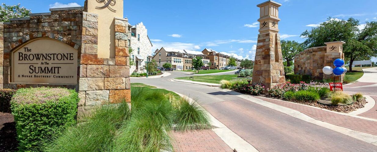 The Brownstone at the Summit sign and entryway road