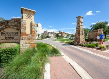 The Brownstone at the Summit sign and entryway road