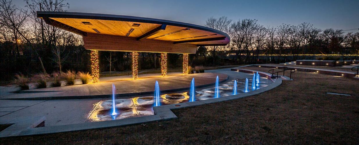 Railyard Park at dusk with Christmas lights and water features