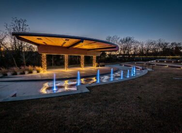 Railyard Park at dusk with Christmas lights and water features