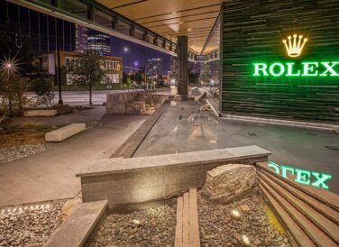 Rolex Plaza outdoor water feature with view of Dallas skyline at night