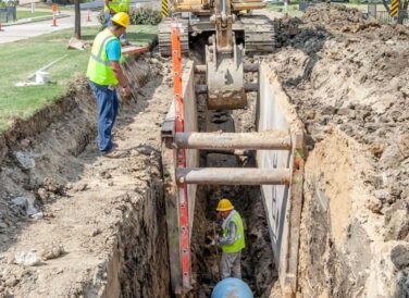 crew working underground in dig site hole at Rochelle Blvd