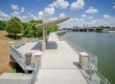 sidewalk trail with awning shade structure by the river at Waco Riverwalk