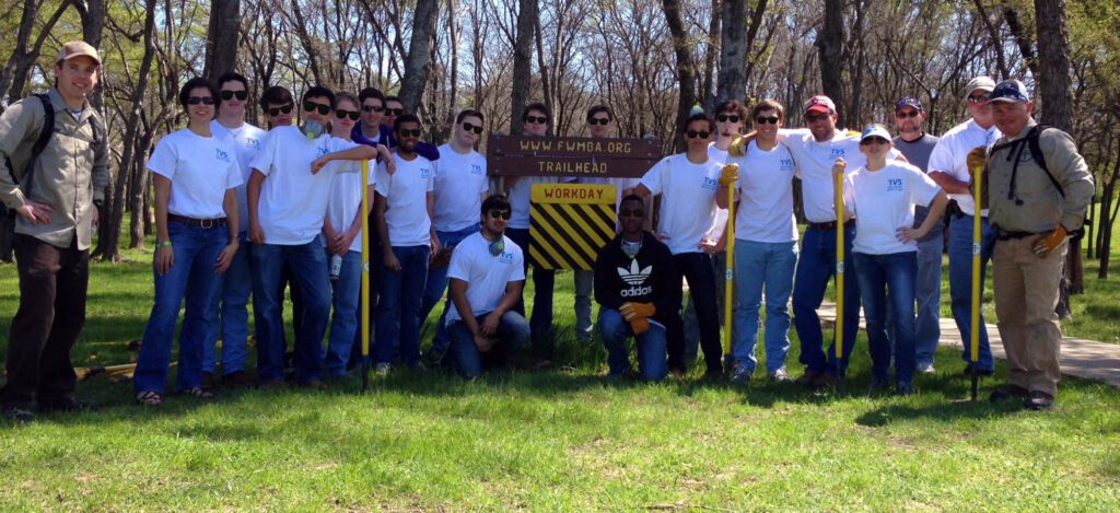 Matt poses with volunteers from Trinity Valley School during a workday.