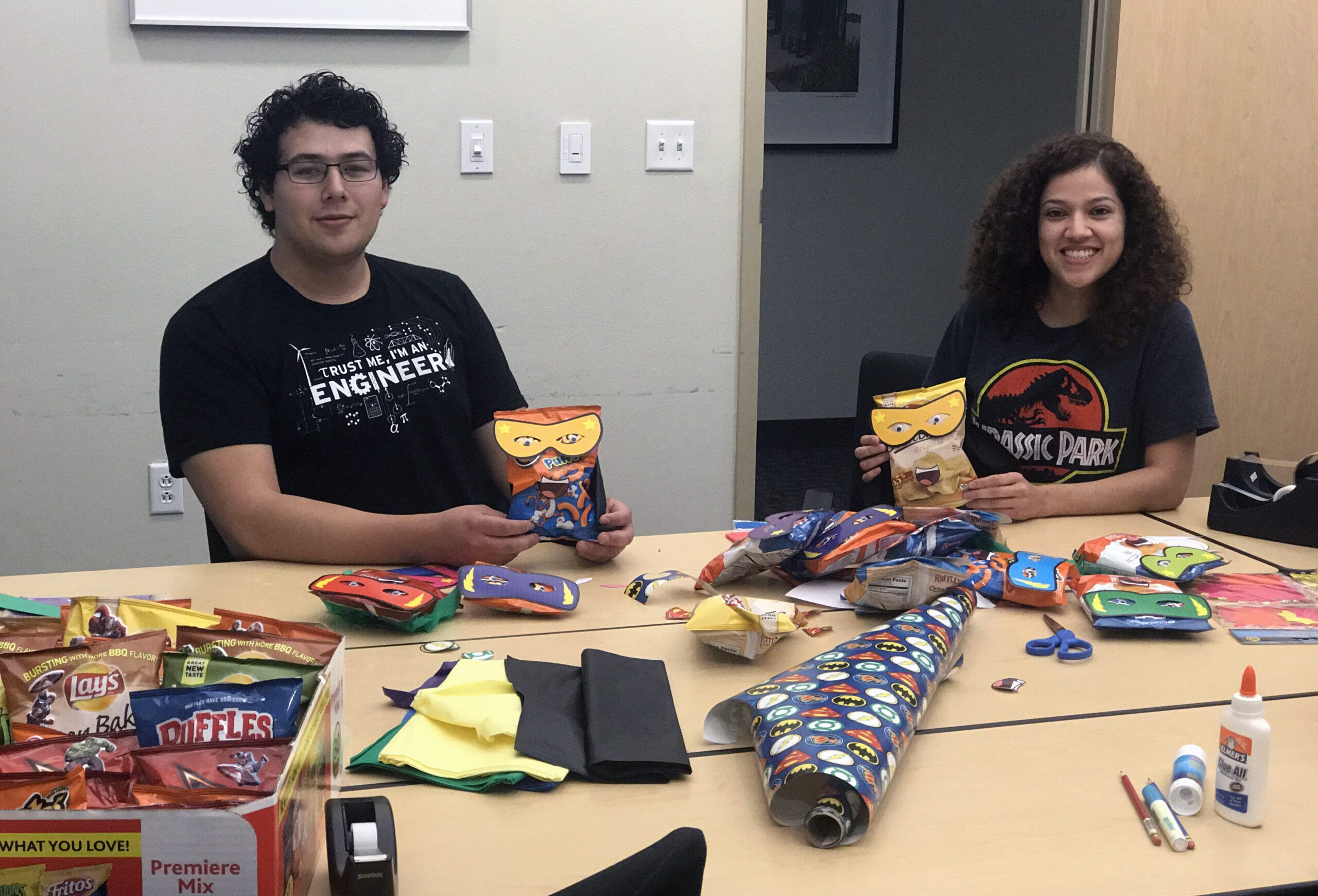 Employees decorate bags of chips in the McAllen office conference room. 