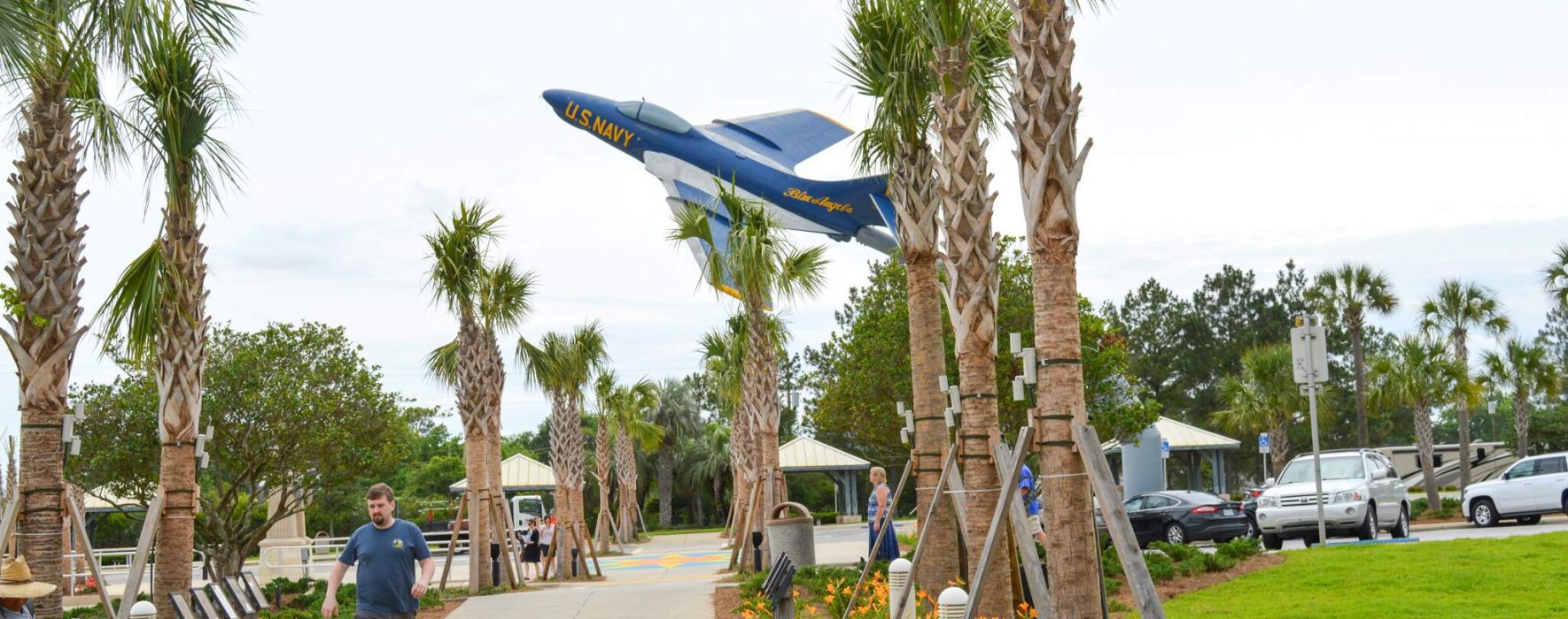 Welcome Center entrance sidewalk by blue airplane