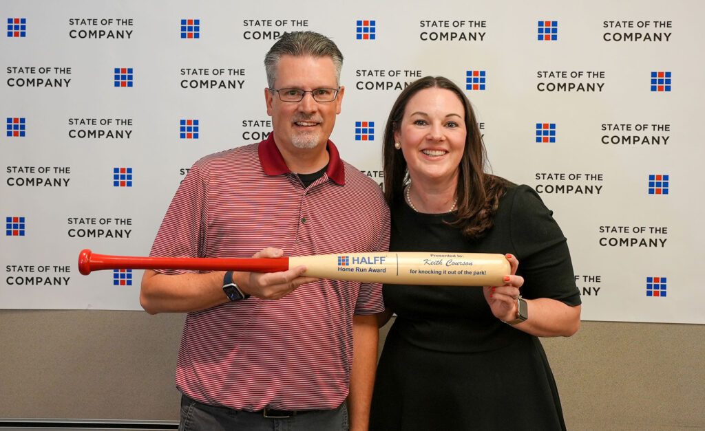 Keith Courson holding Home Run Bat Award with Jessica Baker Daily at Halff
