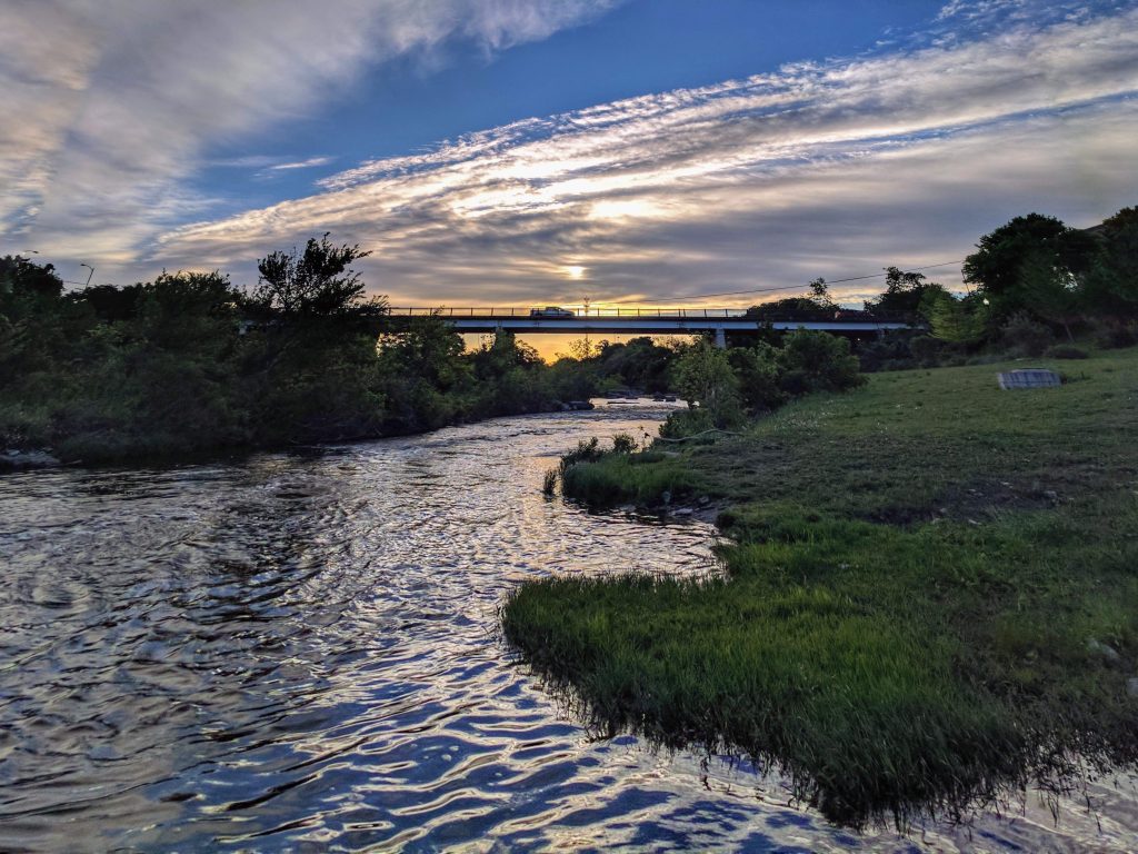 River by grass at sunset