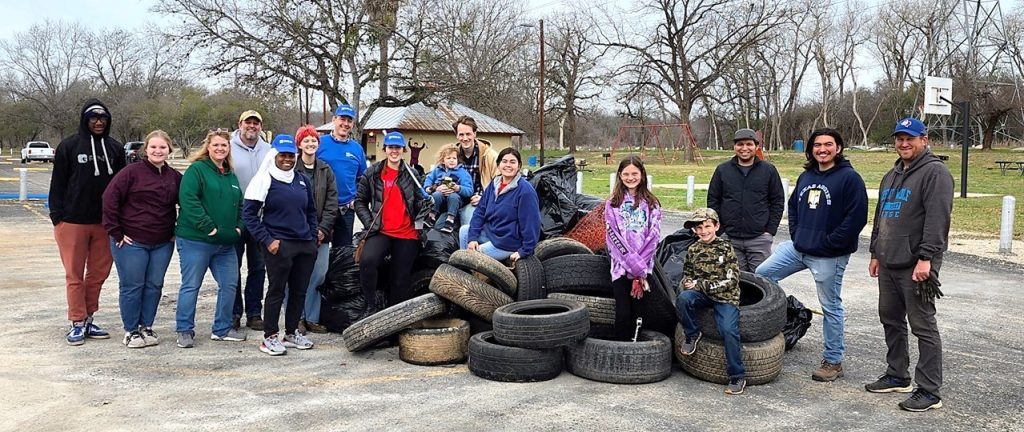 Halff San Antonio employees cleaning up trash together at Rodriquez Park