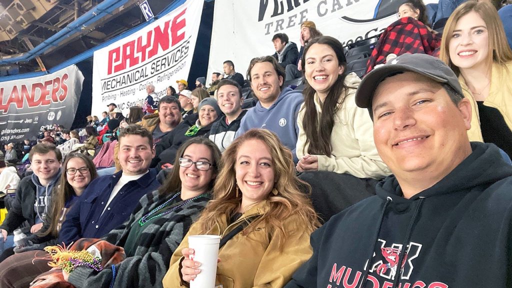 Shreveport Halff employees watching hockey game together in the stands