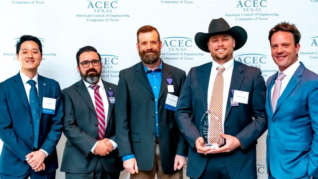 group of 5 Halff employees and attendees accepting 2023 ACEC Texas Engineering Excellence Award at gala