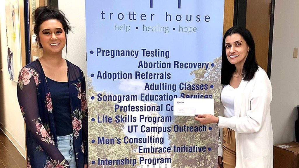 Austin employees presenting HCI donation to Trotter House