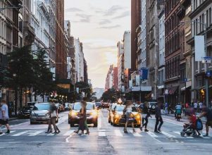 City street with pedestrians crossing, demonstrating Safe Strets For All grant program