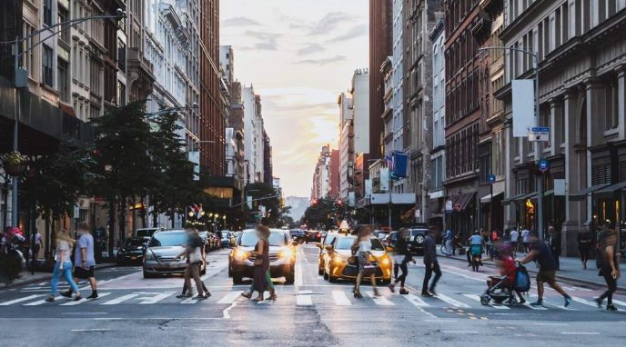 City street with pedestrians crossing, demonstrating Safe Strets For All grant program
