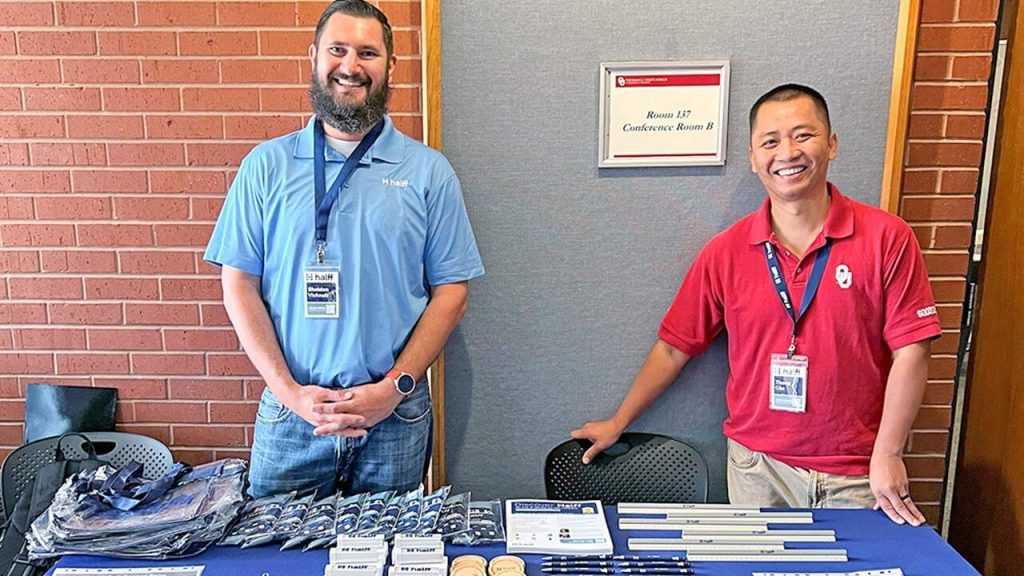 Recruiters from Halff Texas offices standing at booth at University of Oklahoma