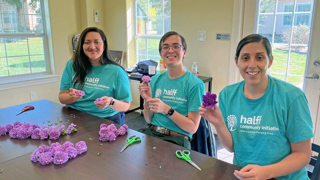 Halff Conroe volunteers pruning purple flowers for Flowers on the Lake event