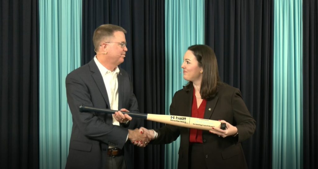 Halff Chief People Officer Jessica Baker Daily presenting the Home Run Award to Mark Edwards