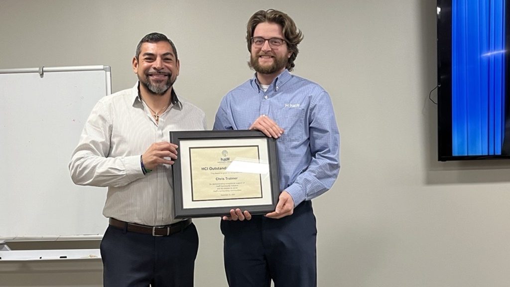 Halff's Erik Verduzco presenting the HCI Outstanding Volunteer Award to Chris Tralmer