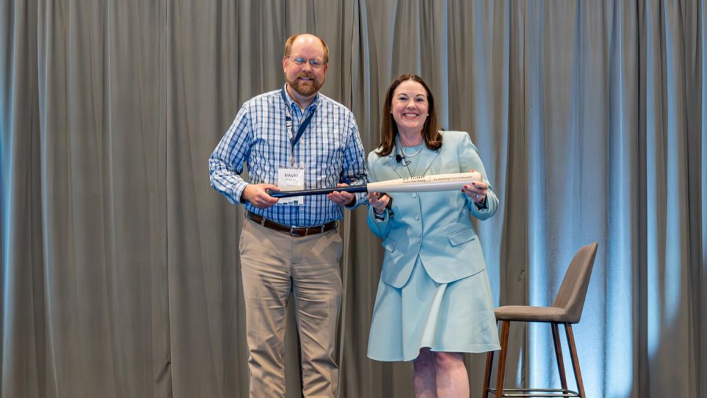 David Burkett accepting the Halff Home Run Award from Halff President and CEO Jessica Baker Daily