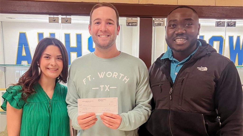 Fort Worth employees delivering HCI check donation
